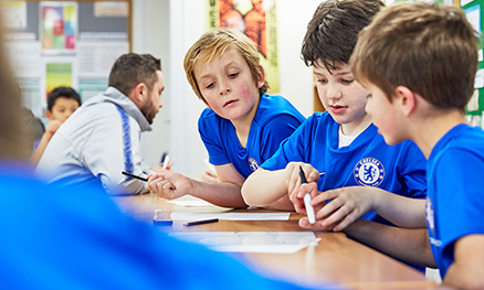 Children learning on football course