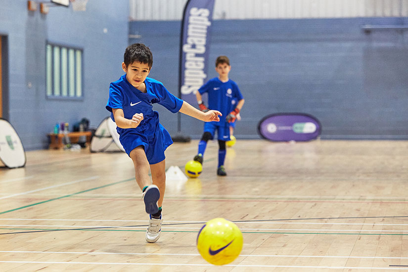 Boy playing football at Chelsea FC Foundation camp